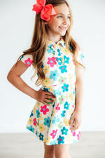 Short-sleeve polo dress in a groovy floral print with ruffled collar, button placket, and A-line skirt