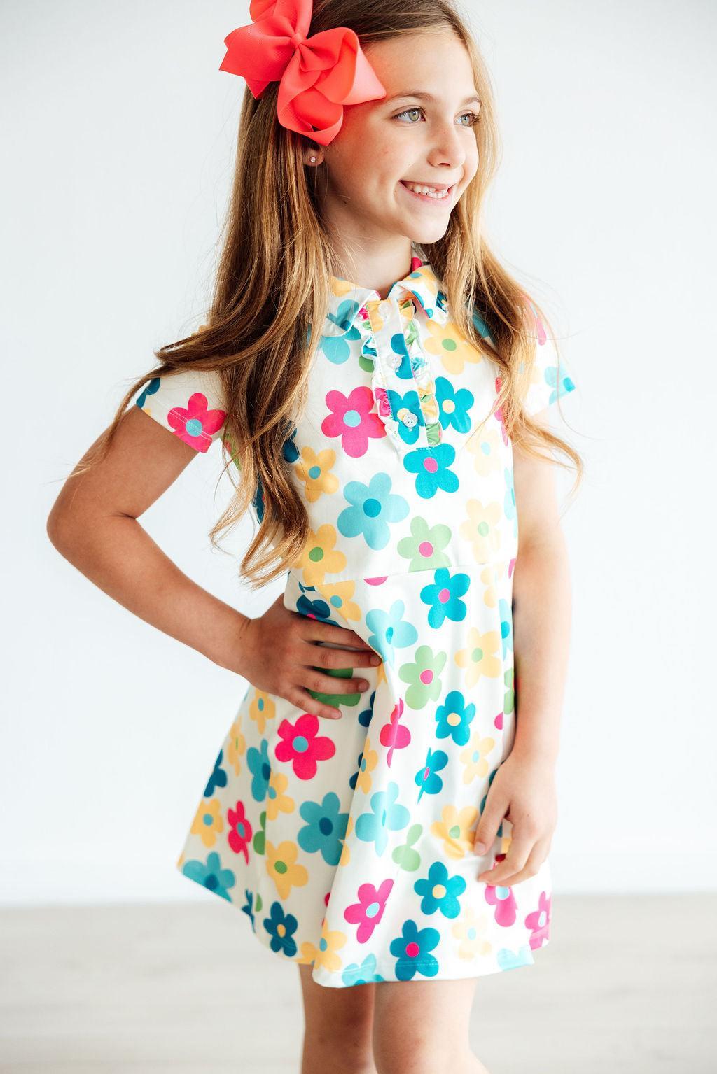 Short-sleeve polo dress in a groovy floral print with ruffled collar, button placket, and A-line skirt