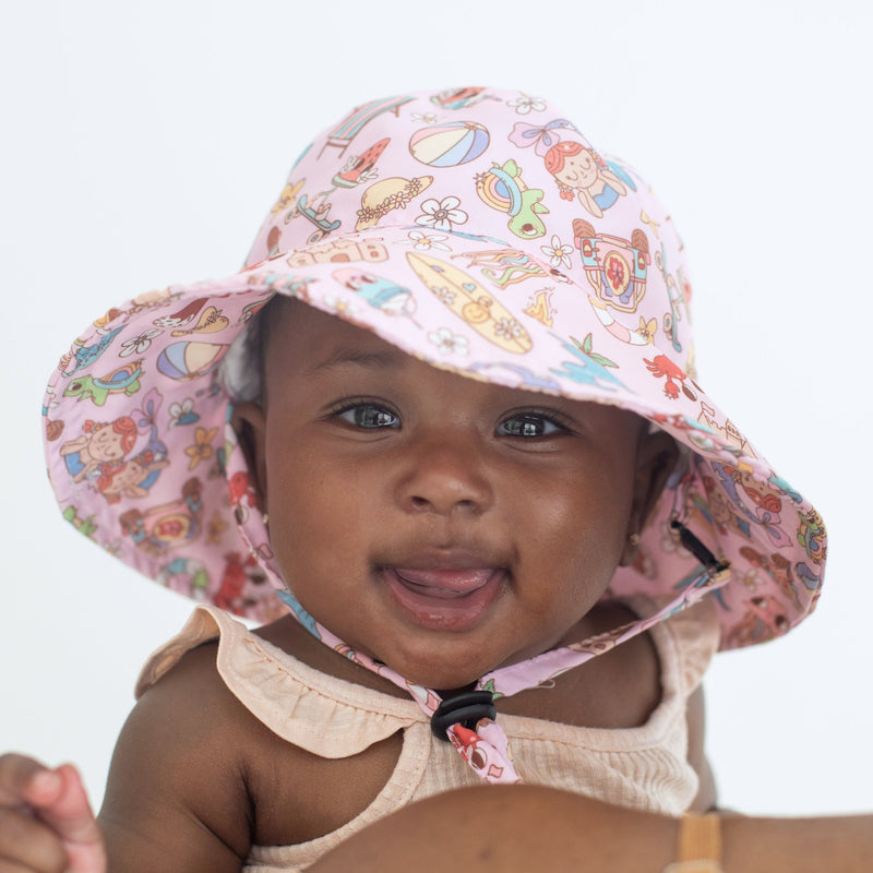 Baby wearing Summer Dream sun hat for kids, offering UV protection.
