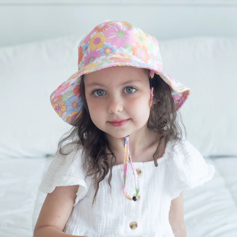 Baby wearing a retro floral sun hat, perfect for UV protection and comfort.
