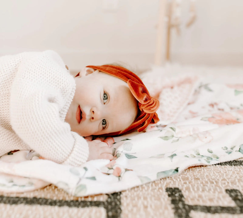 Premium baby blanket with peach floral design and soft minky dot texture.