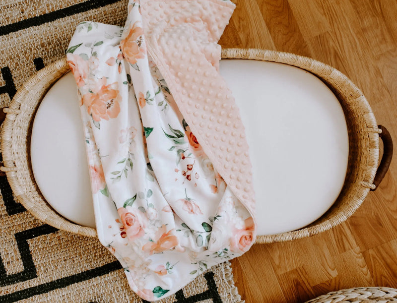 Premium baby and toddler blanket with peach floral pattern and minky dot texture.