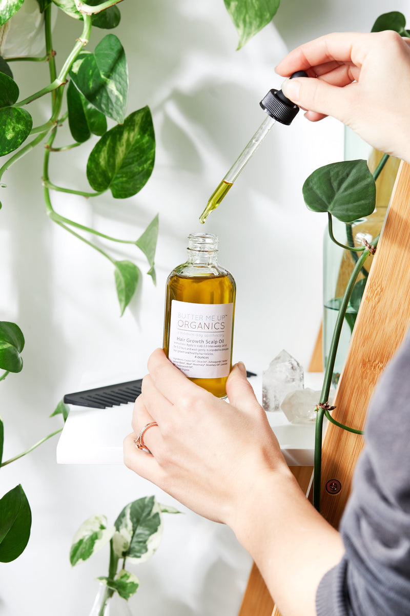 Organic scalp treatment oil in glass bottle with dropper, promoting healthy hair growth with herbal ingredients.