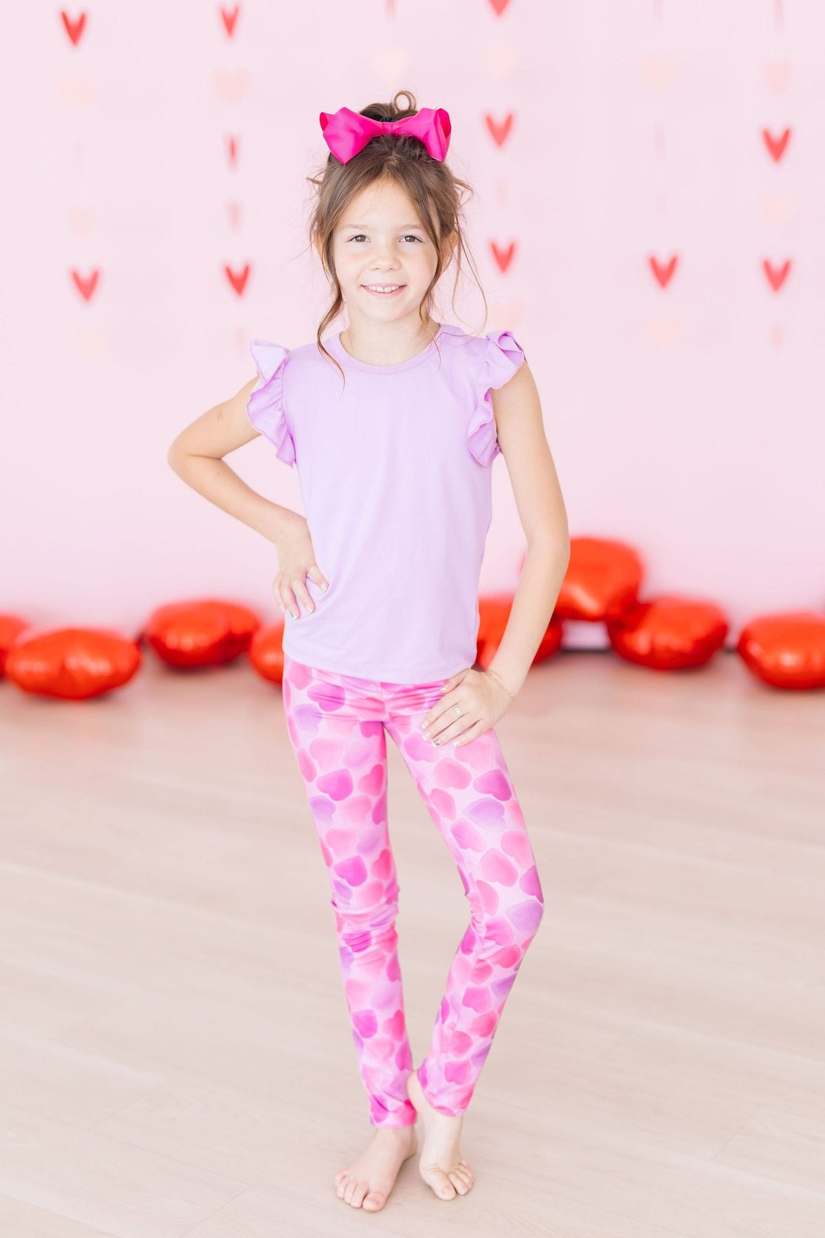 Mila & Rose Happy Heart Day baby leggings with red heart print.
