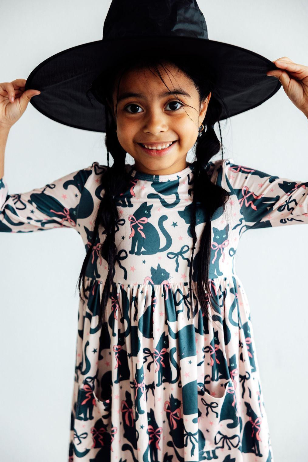 Twirl dress with Hocus Purr-cus cat print, 3/4 sleeves, and side pockets on a full twirly skirt