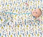 Baby footie pajamas with a busy builders construction print, long sleeves, full-length zipper, and covered feet