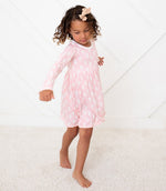 Long sleeve fairies-print dress in pink with polka dots, shown on a toddler.