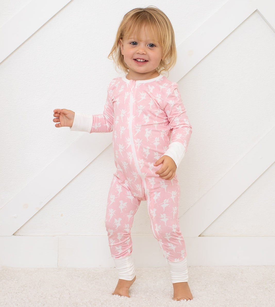 Baby coverall in a whimsical fairy print with a full-length two-way zipper and convertible footed design.