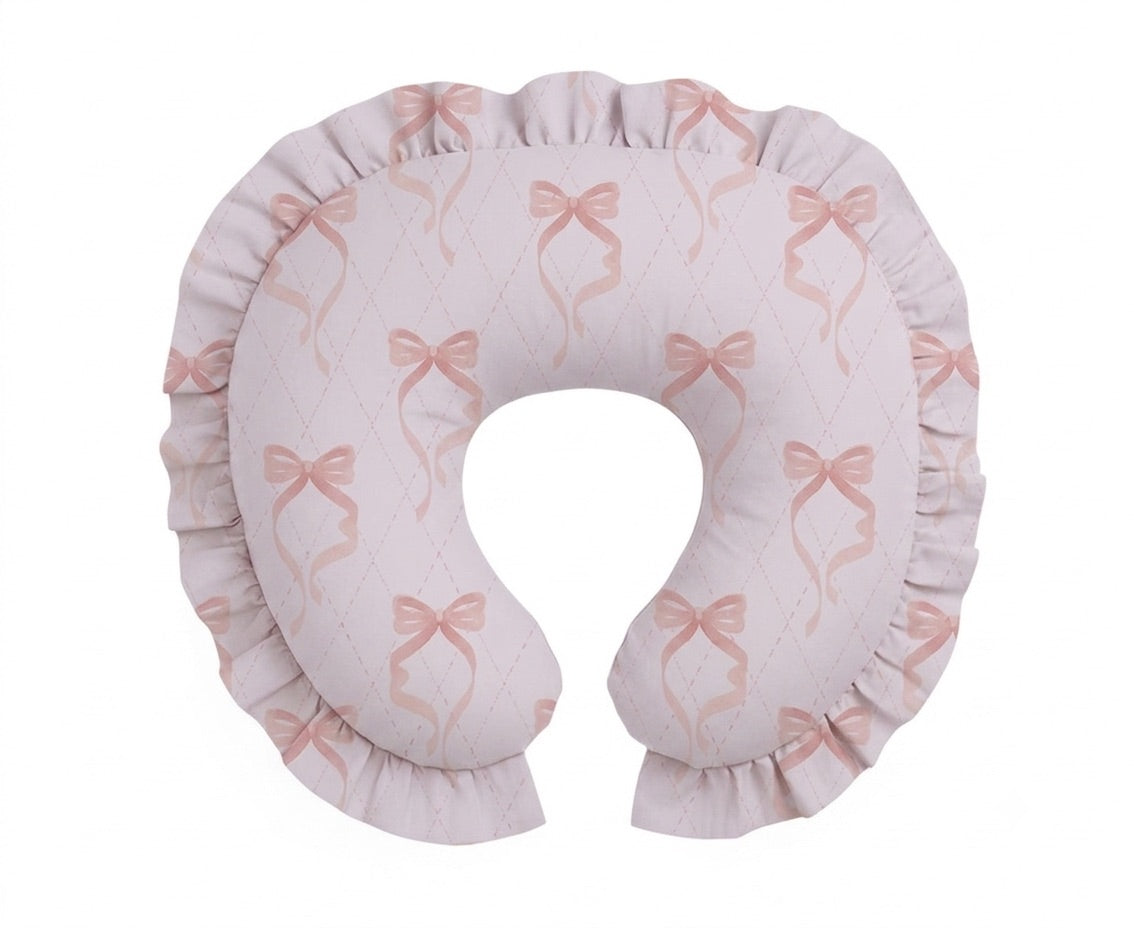 Pink nursing pillow cover with bow and ruffle trim, made of cotton