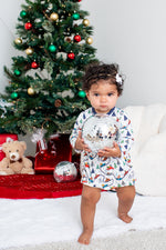 Long-sleeve baby bodysuit dress with a festive holiday design and snap closure at the inseam.