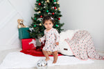 Long-sleeve baby bodysuit dress with a pine tree pattern and snap closure at the inseam
