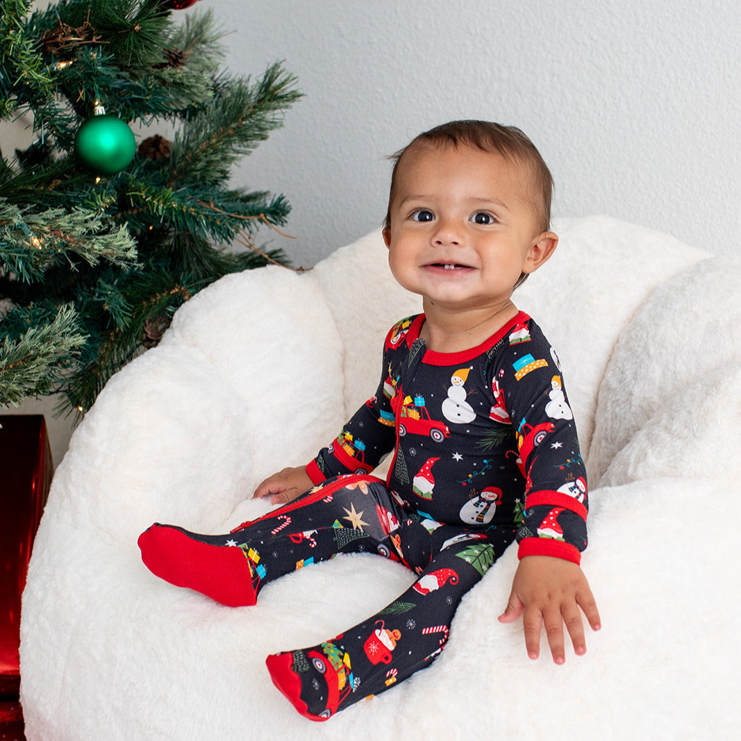 Baby footie pajamas with a festive Christmas tree print and full-length front zipper