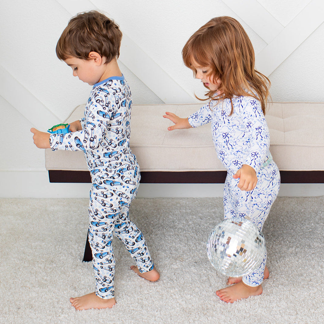 Long-sleeve pajama set with blue bows, menorahs, dreidels and Stars of David on a light background