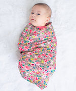Savanna Rose swaddle blanket in a soft rose-toned floral print, spread flat