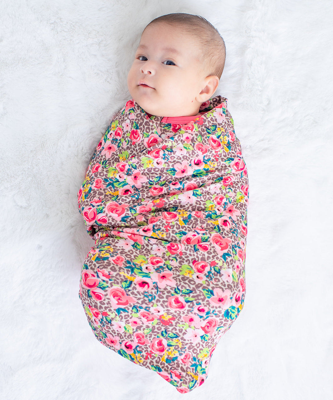 Savanna Rose swaddle blanket in a soft rose-toned floral print, spread flat
