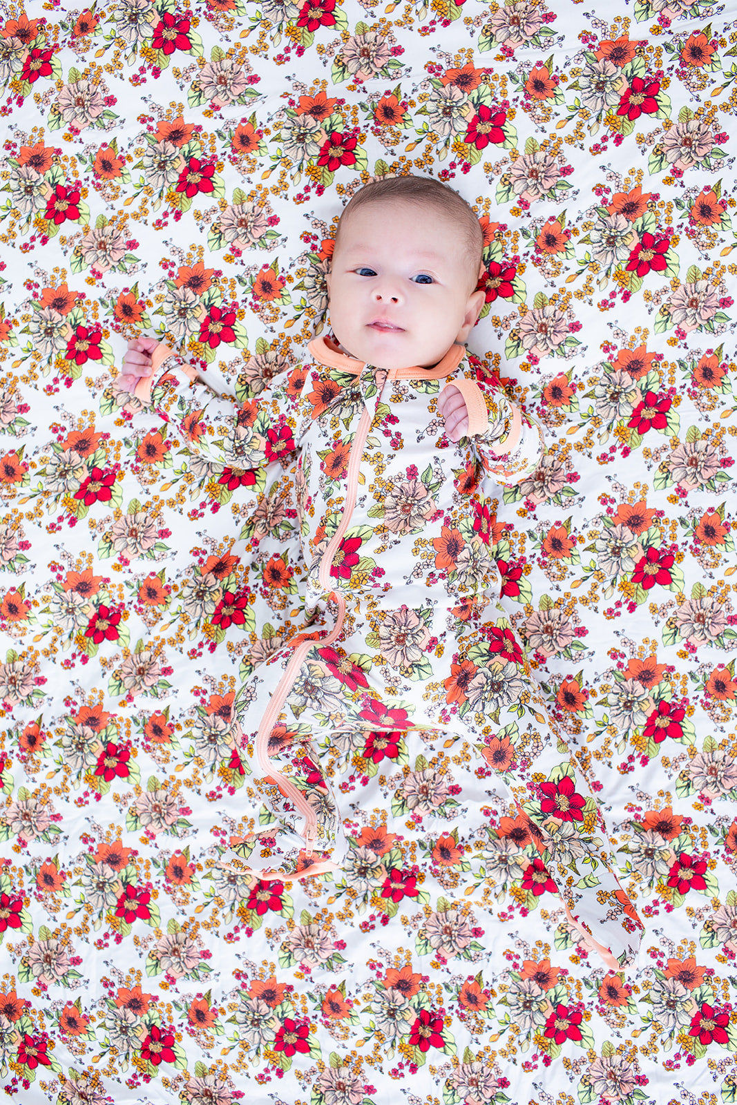Honeyblossom footie pajamas in soft pink floral print with long sleeves and covered feet
