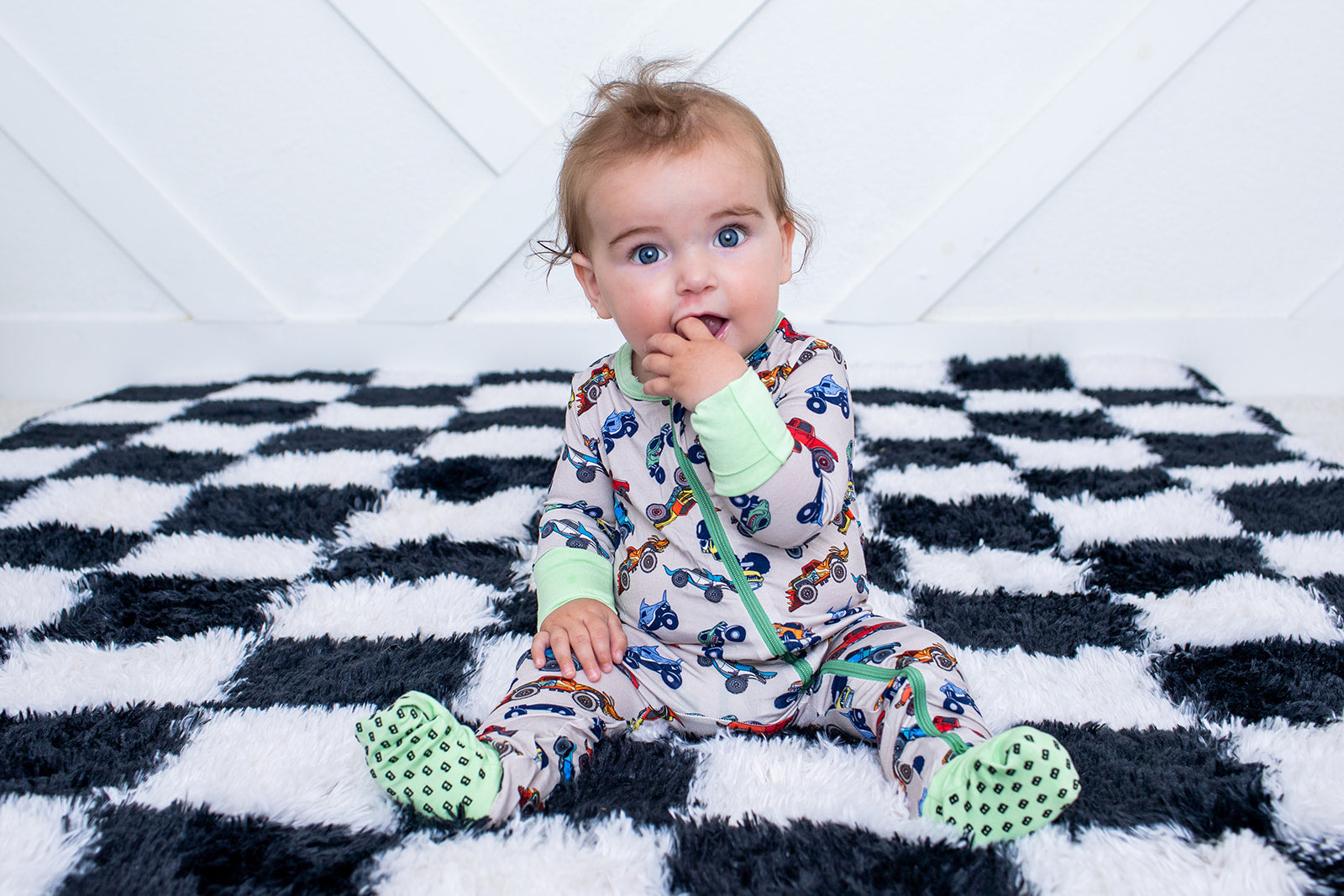 Convertible baby coverall in a wild wheels print of cars and trucks with a full-length front zipper