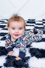 Convertible coverall in an Apex Dreams print with long sleeves, a full-length zipper, and footed legs.