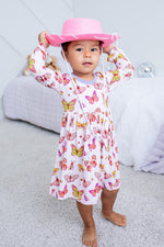 Long-sleeve toddler twirl dress in soft butter-yellow floral bloom pattern
