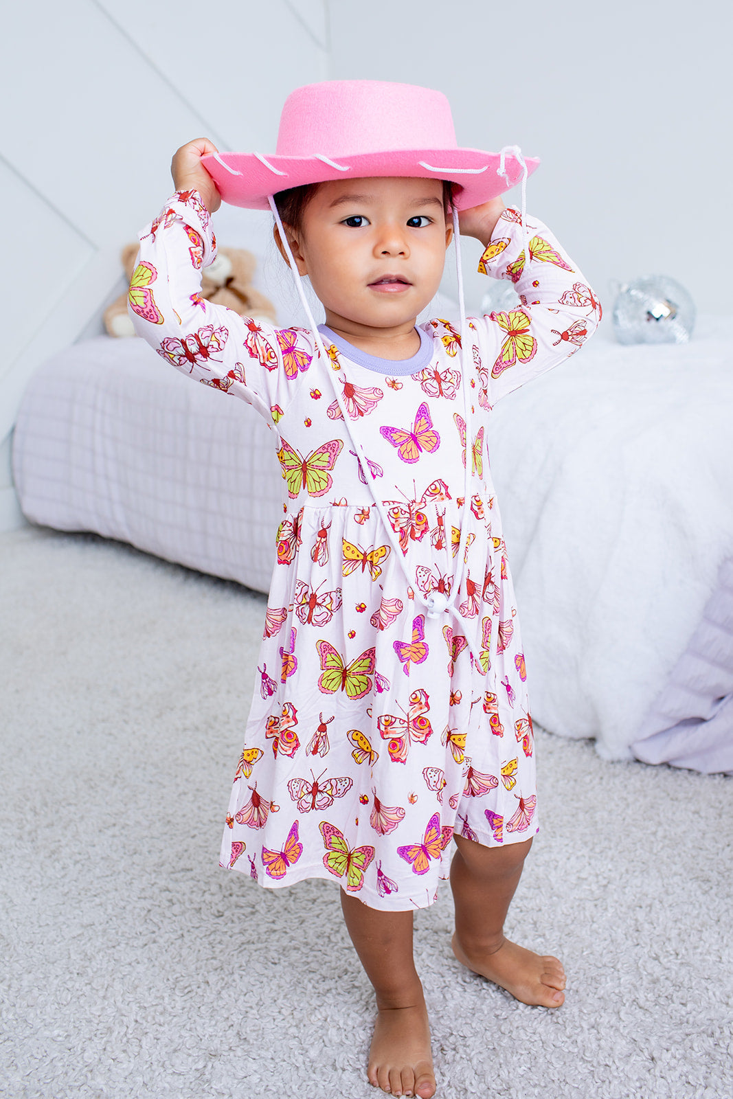 Long-sleeve toddler twirl dress in soft butter-yellow floral bloom pattern