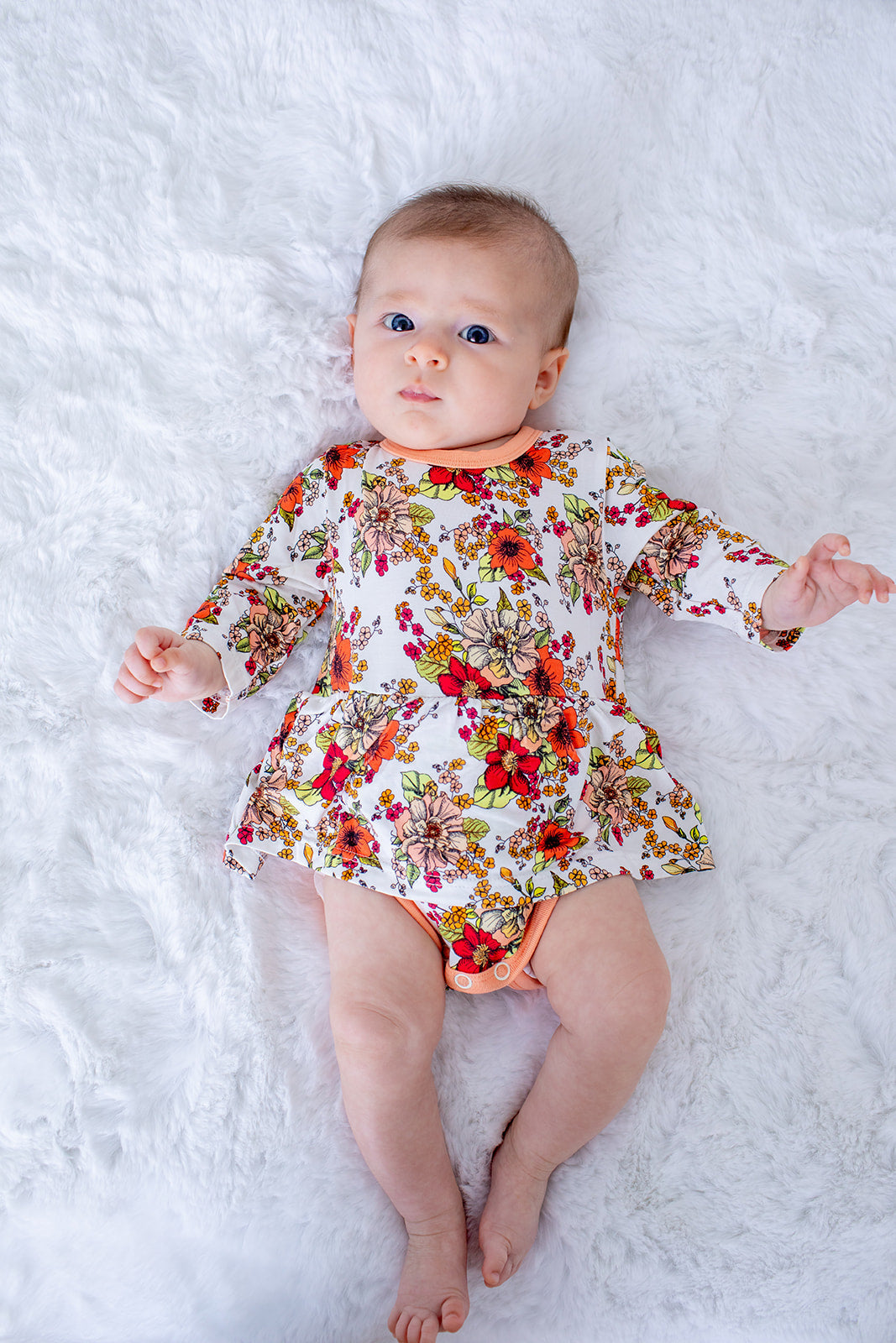 Long-sleeve bodysuit dress in pink Honeyblossom floral print with snap closure at the inseam