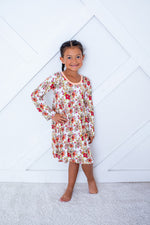 Long-sleeve toddler dress in a soft pink floral Honeyblossom pattern with a full twirl skirt