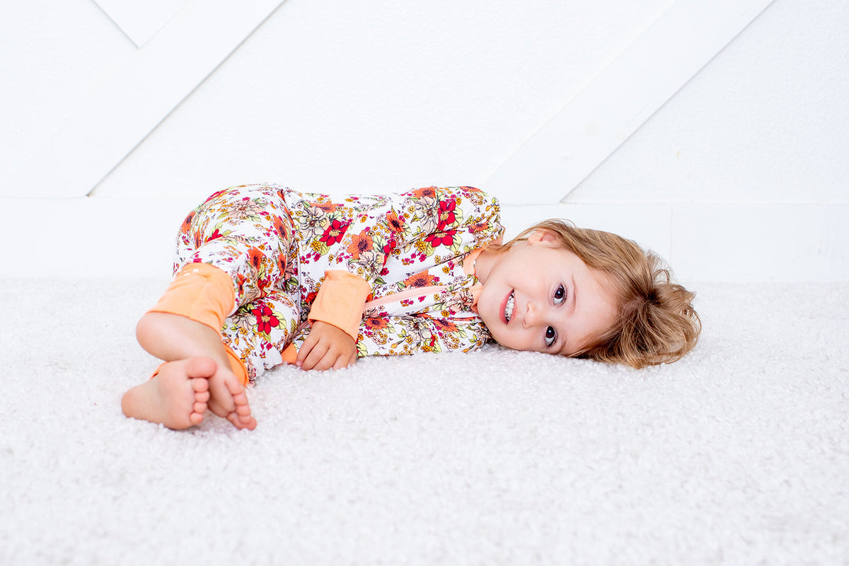 Baby convertible coverall in a honeyblossom floral print with a full-length two-way zipper and footed legs