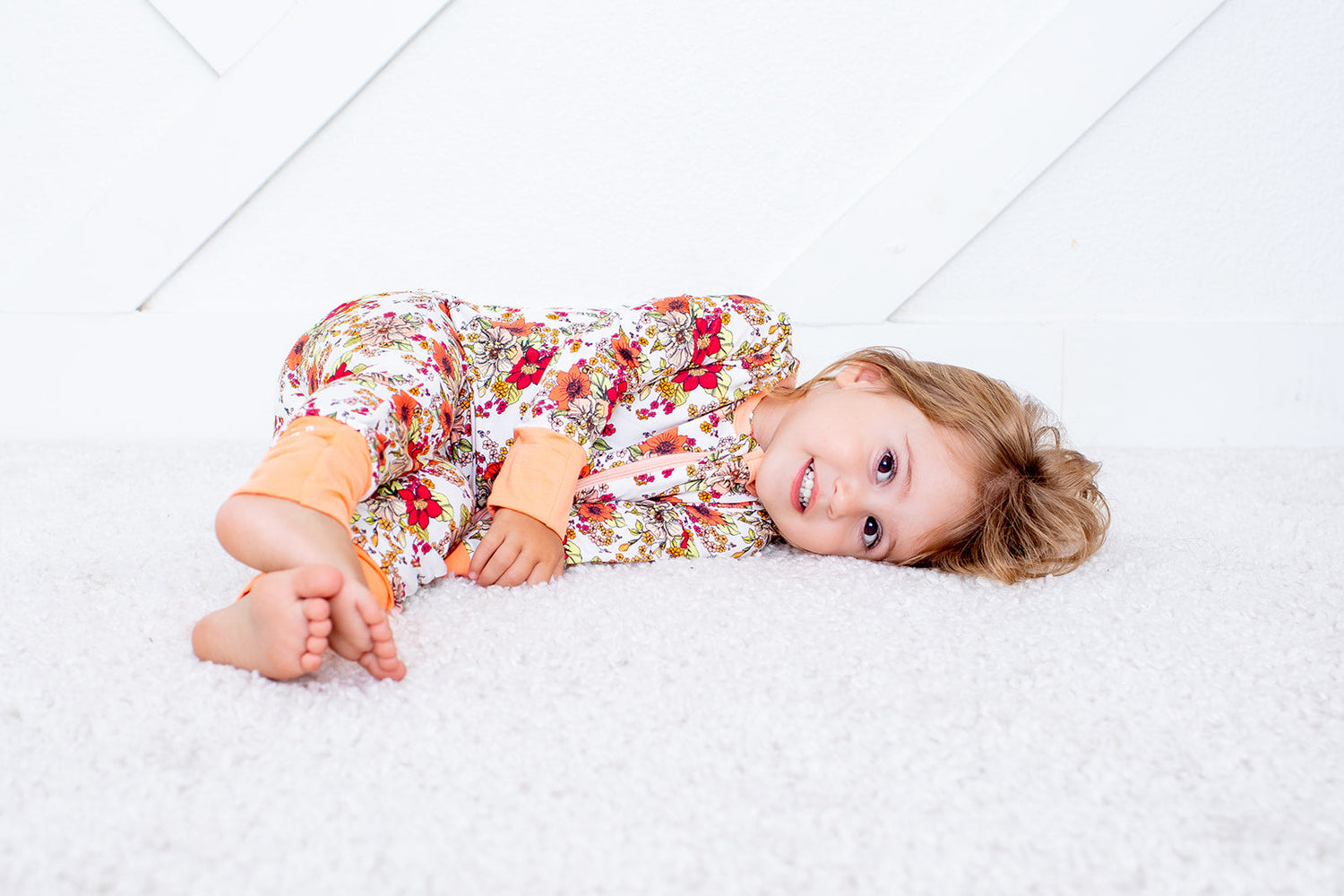 Baby convertible coverall in a honeyblossom floral print with a full-length two-way zipper and footed legs