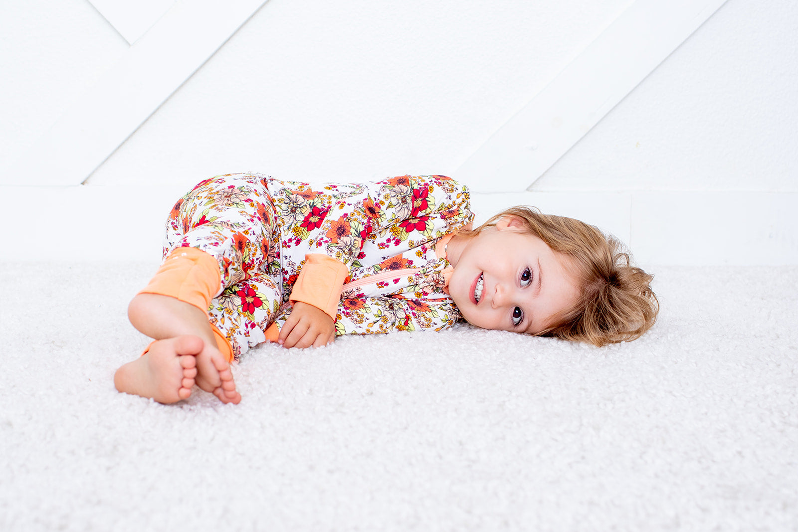 Baby convertible coverall in a honeyblossom floral print with a full-length two-way zipper and footed legs