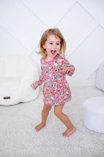 Long-sleeve bodysuit dress in a rosy pink floral print with snap closure at the inseam