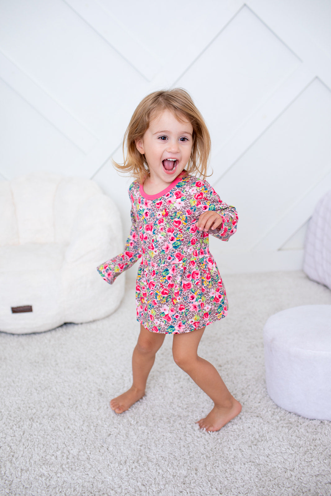 Long-sleeve bodysuit dress in a rosy pink floral print with snap closure at the inseam