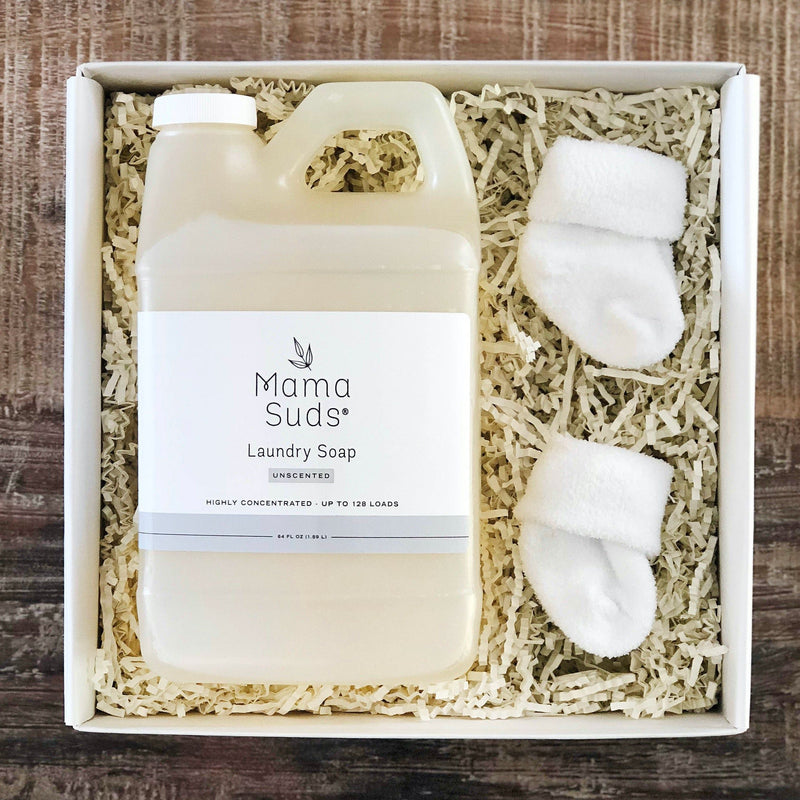 Eco-friendly MamaSuds Laundry Detergent Soap, nontoxic and safe for sensitive skin, displayed with baby booties in packaging.