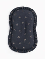 Baby lounger cover in blue dandelion print cotton with a ruffle trim along the top edge