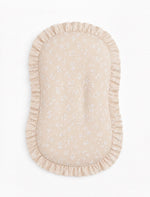 Baby lounger cover in beige with a white floral print and ruffle trim along the top edge