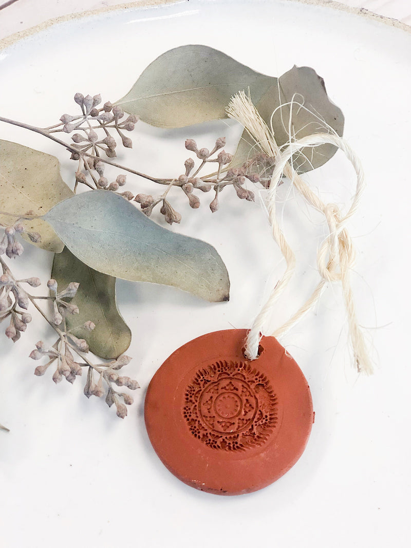 Terra Cotta Essential Oil Diffuser with twine loop for air freshening.