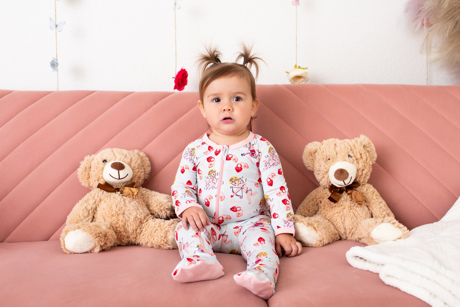 Baby footie pajamas in a pink Cupids Bow print with long sleeves and full-length front zipper