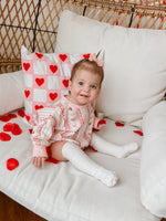 Baby wearing Laced with Love organic cotton sweatshirt romper with lace trim detail, smiling.