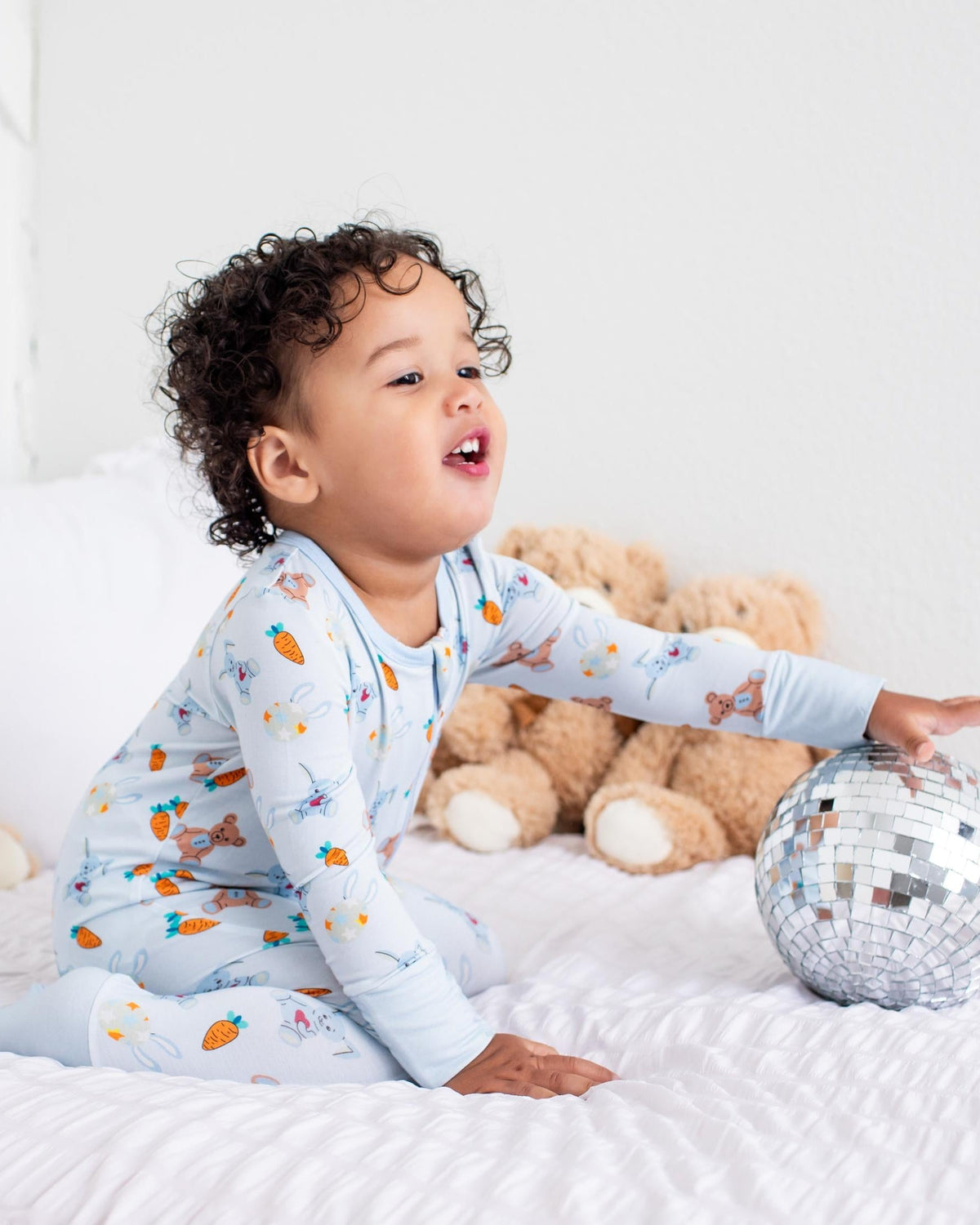 Baby coverall in a carrot print with long sleeves, footed legs, and a front zipper