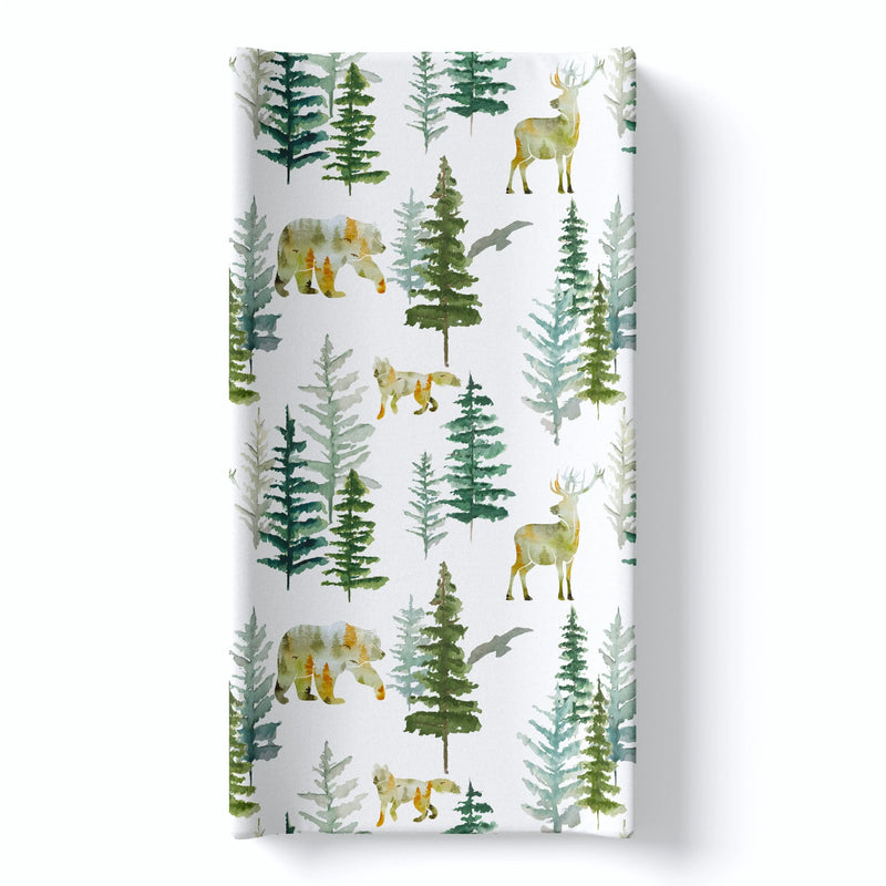 Forest-themed changing pad cover with trees, bears, and deer, fits most pads, soft and stretchy fabric.