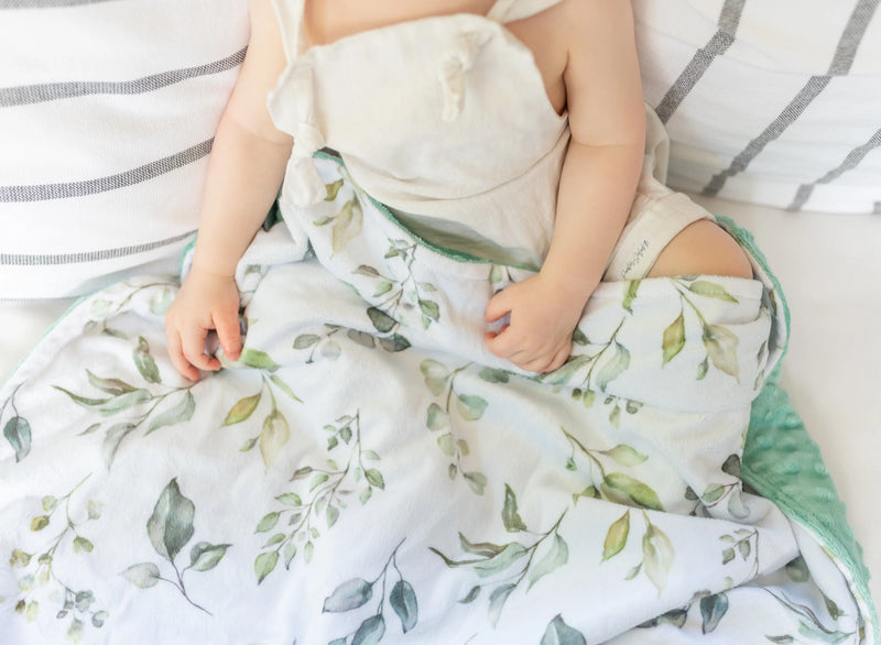 Premium baby and toddler minky blanket with eucalyptus greenery pattern.