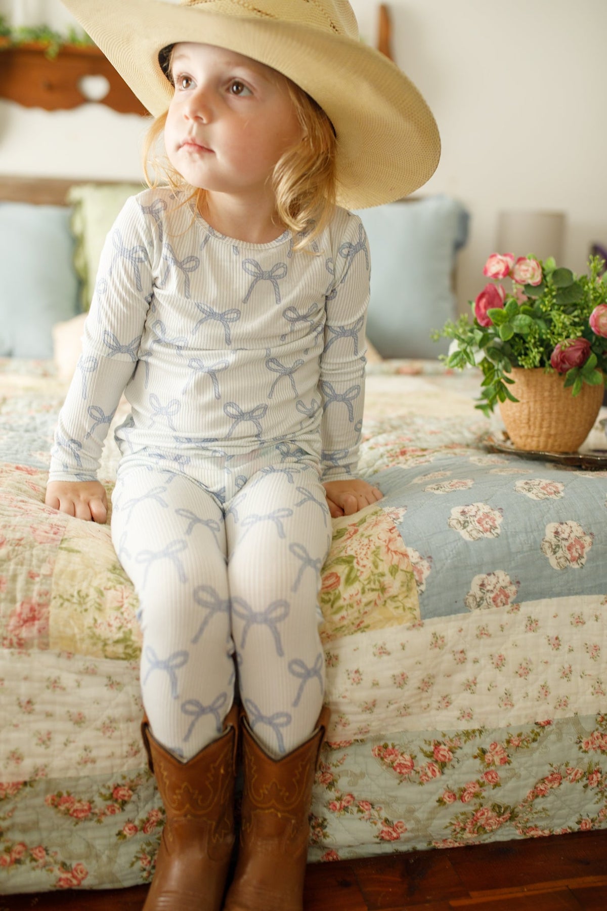 Two-piece blue ribbed long-sleeve top and pants pajama set for a child.