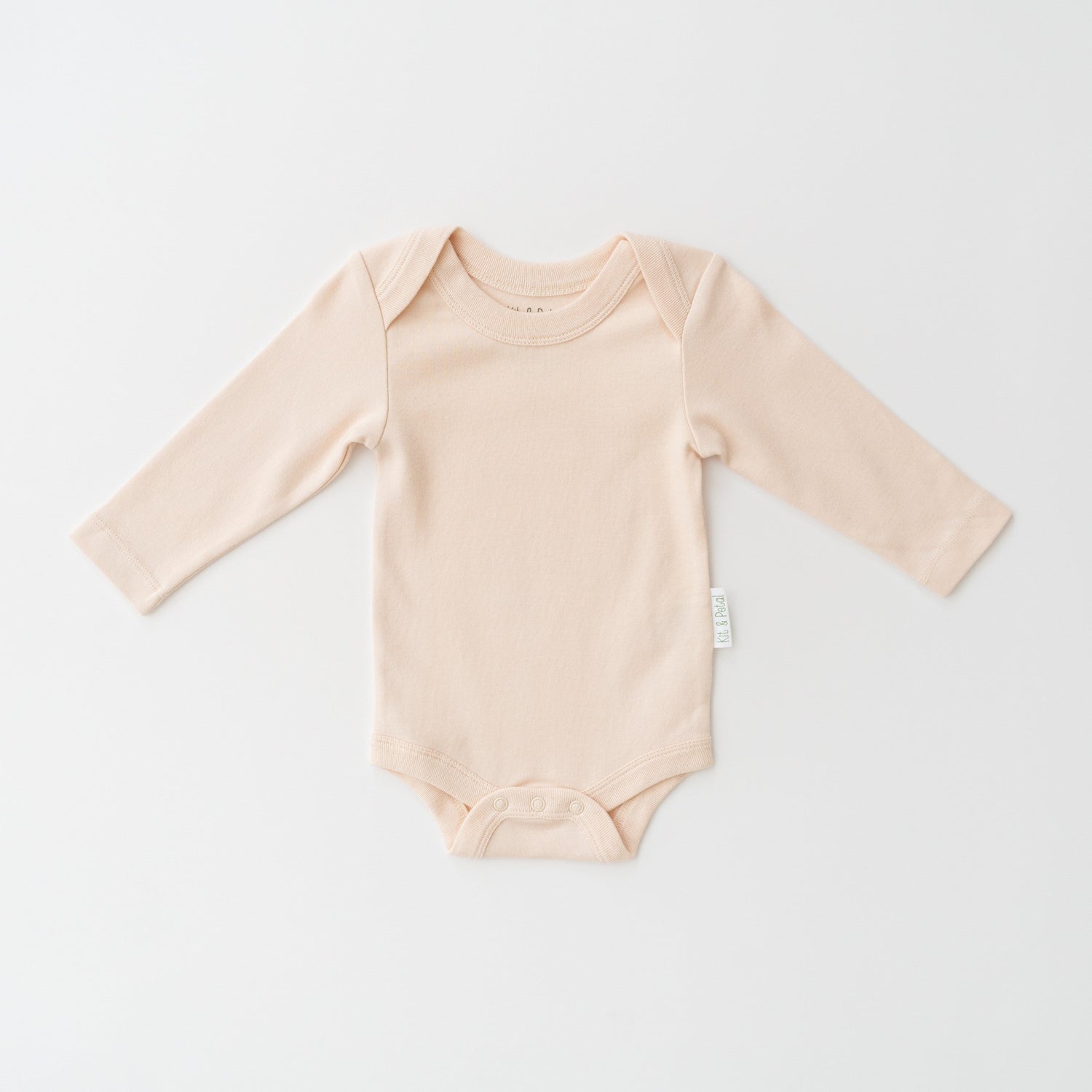 Long sleeve baby bodysuit in rosy peach with envelope neckline and bottom snap buttons
