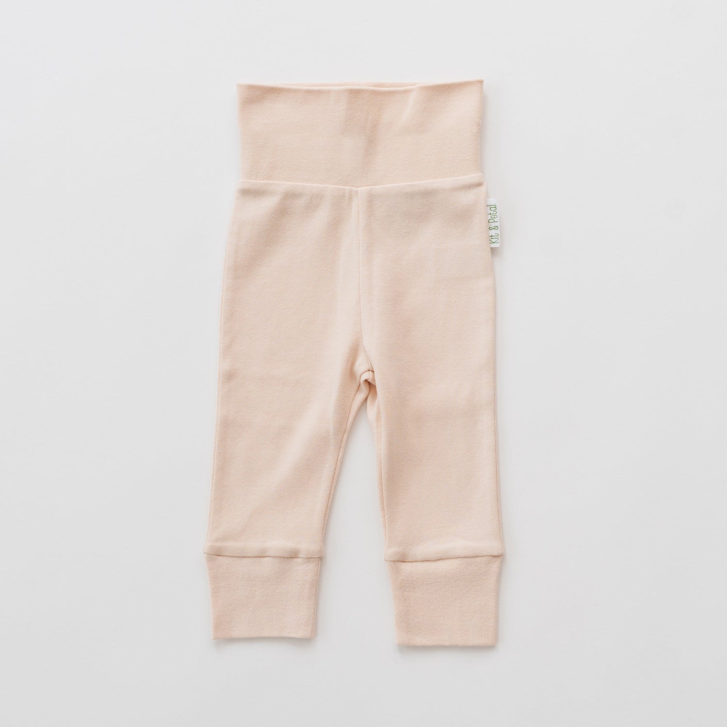 Fold-over baby pants in rosy peach with a wide folded waistband