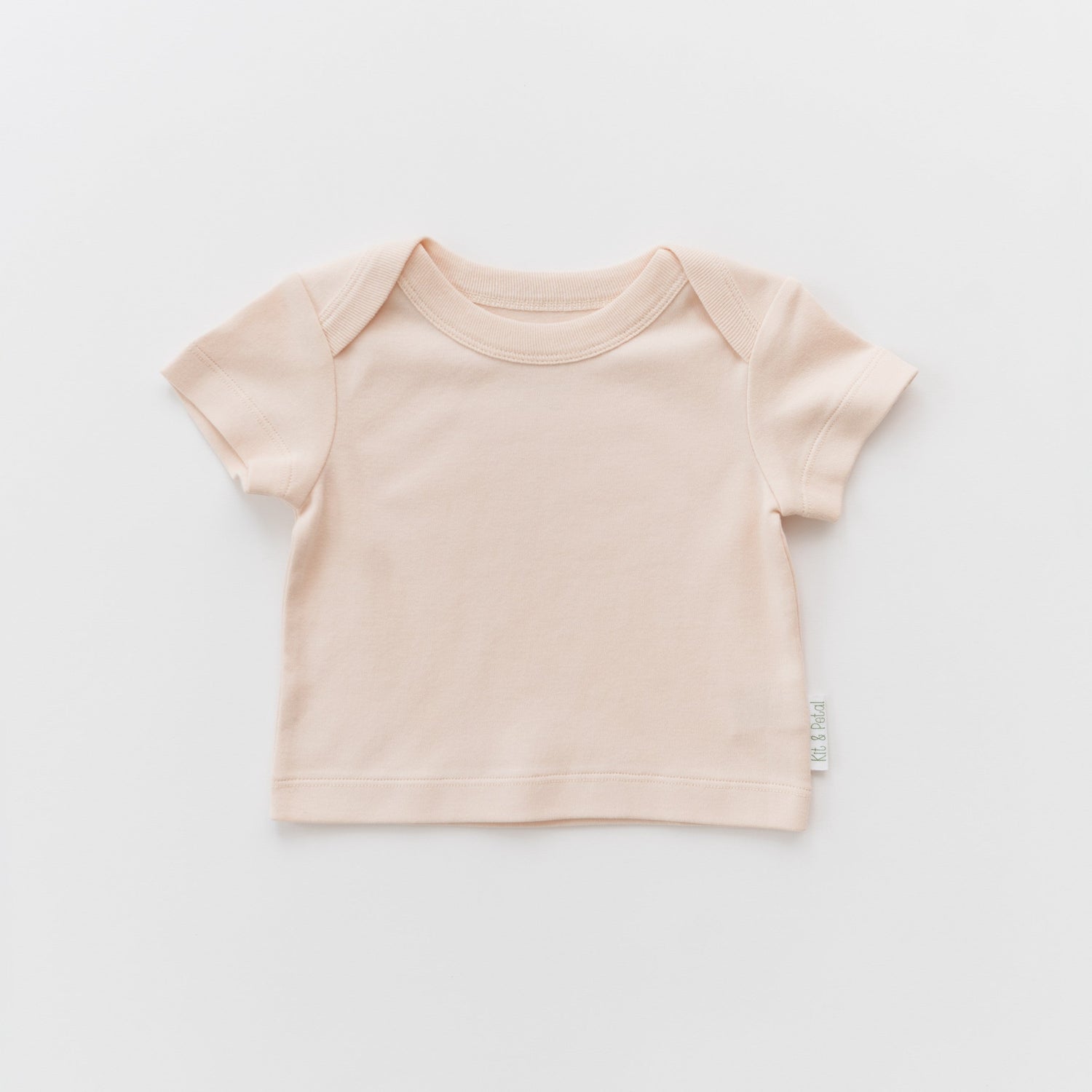 Short sleeve baby shirt in rosy peach with an envelope neckline