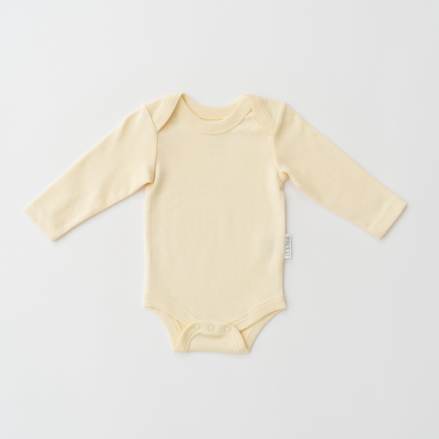 Long sleeve baby bodysuit in sunny yellow with envelope neckline and bottom snap closure