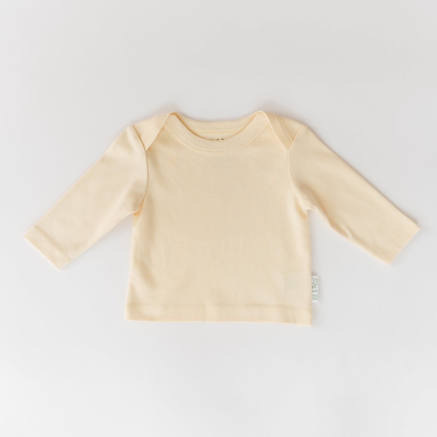 Long sleeve baby shirt in sunny yellow with an envelope neckline