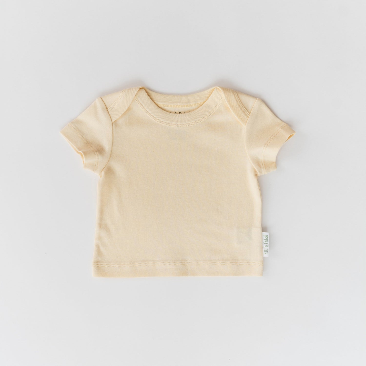 Short sleeve baby shirt in sunny yellow with an envelope neckline