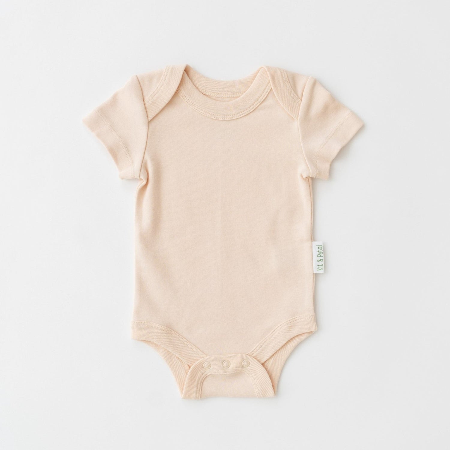 Short sleeve baby bodysuit in rosy peach with envelope neckline and snap buttons