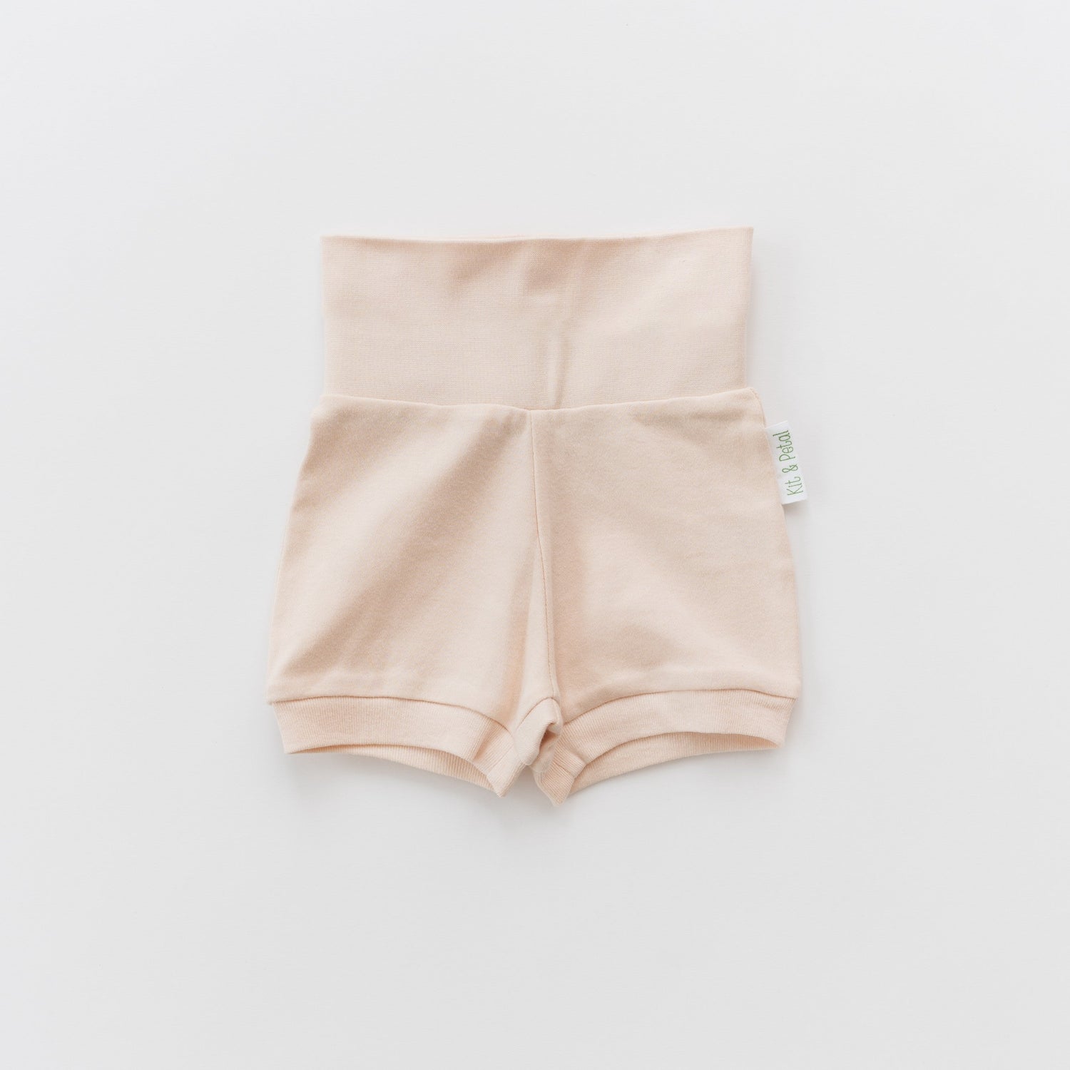Fold-over baby shorts in rosy peach with a wide fold-over waistband