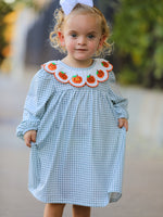 Girls dress with pumpkin embroidery on the skirt and a rounded Peter Pan collar at the neckline